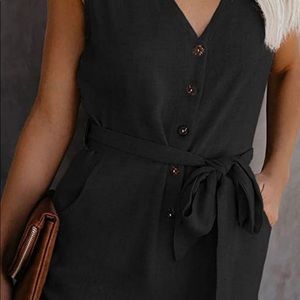 Small Black romper with buttons and black belt.